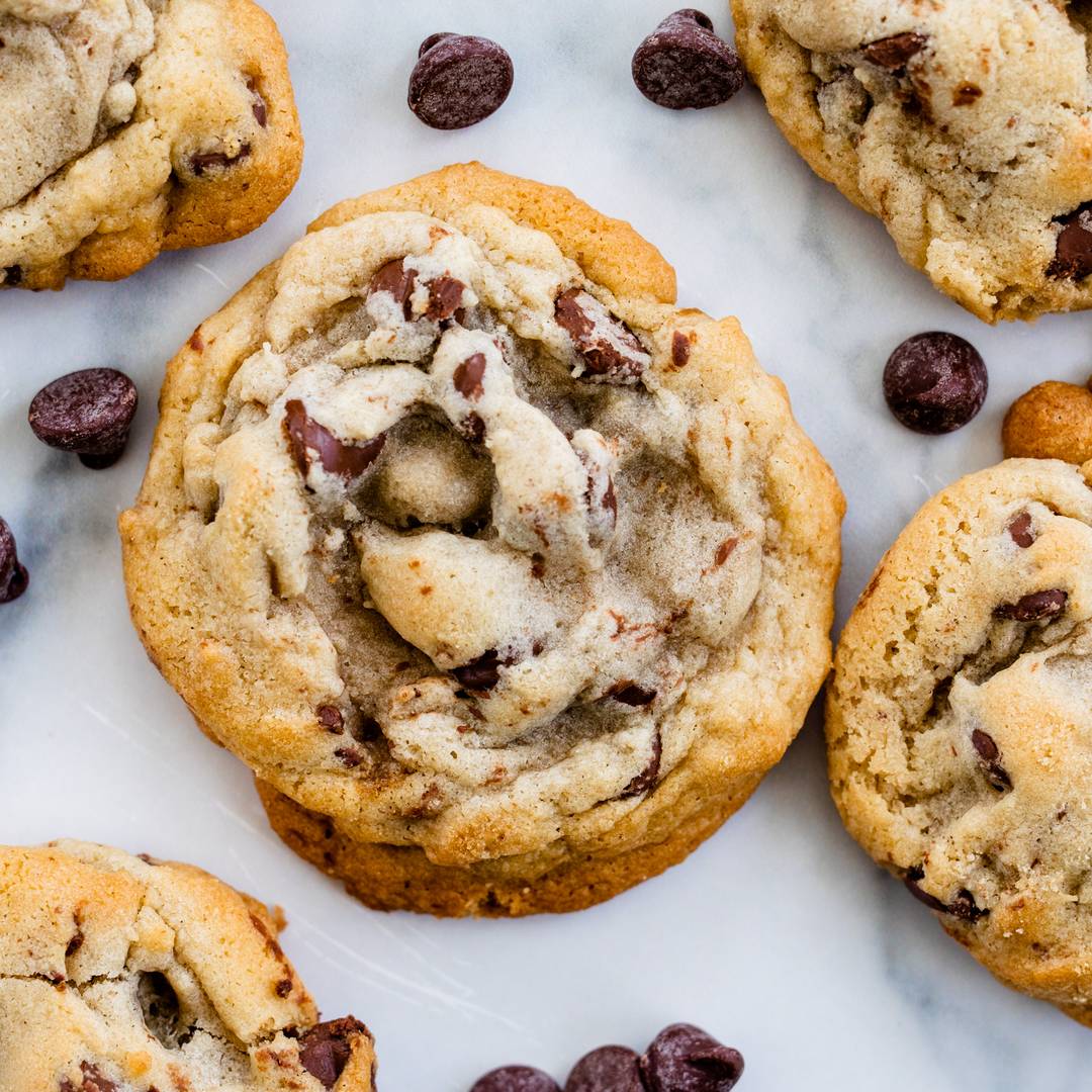 classic chocolate chip cookie sits on marble countertop