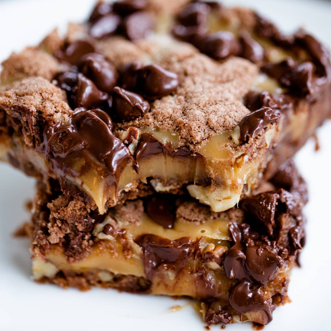 bite taken from gooey caramel chocolate brownie