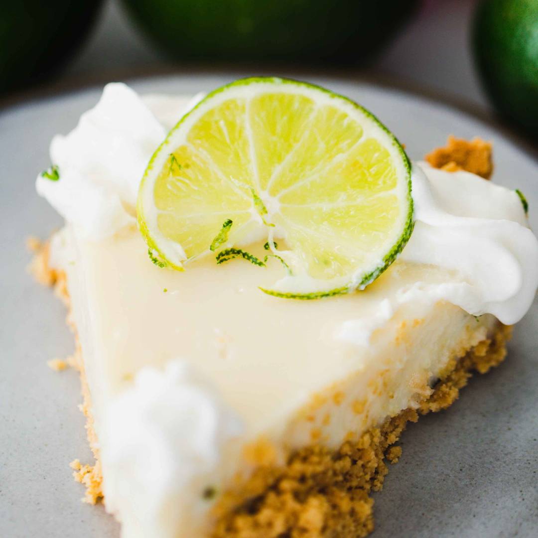 slice of key lime pie sits on plate