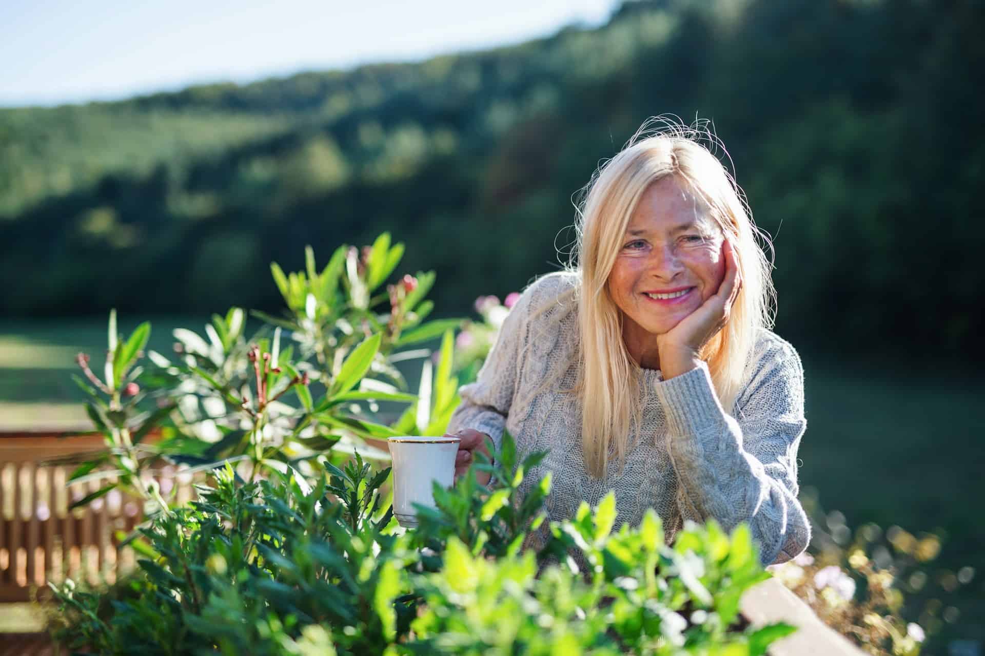 A woman with long blond hair giving herself permission to enjoy the summer.