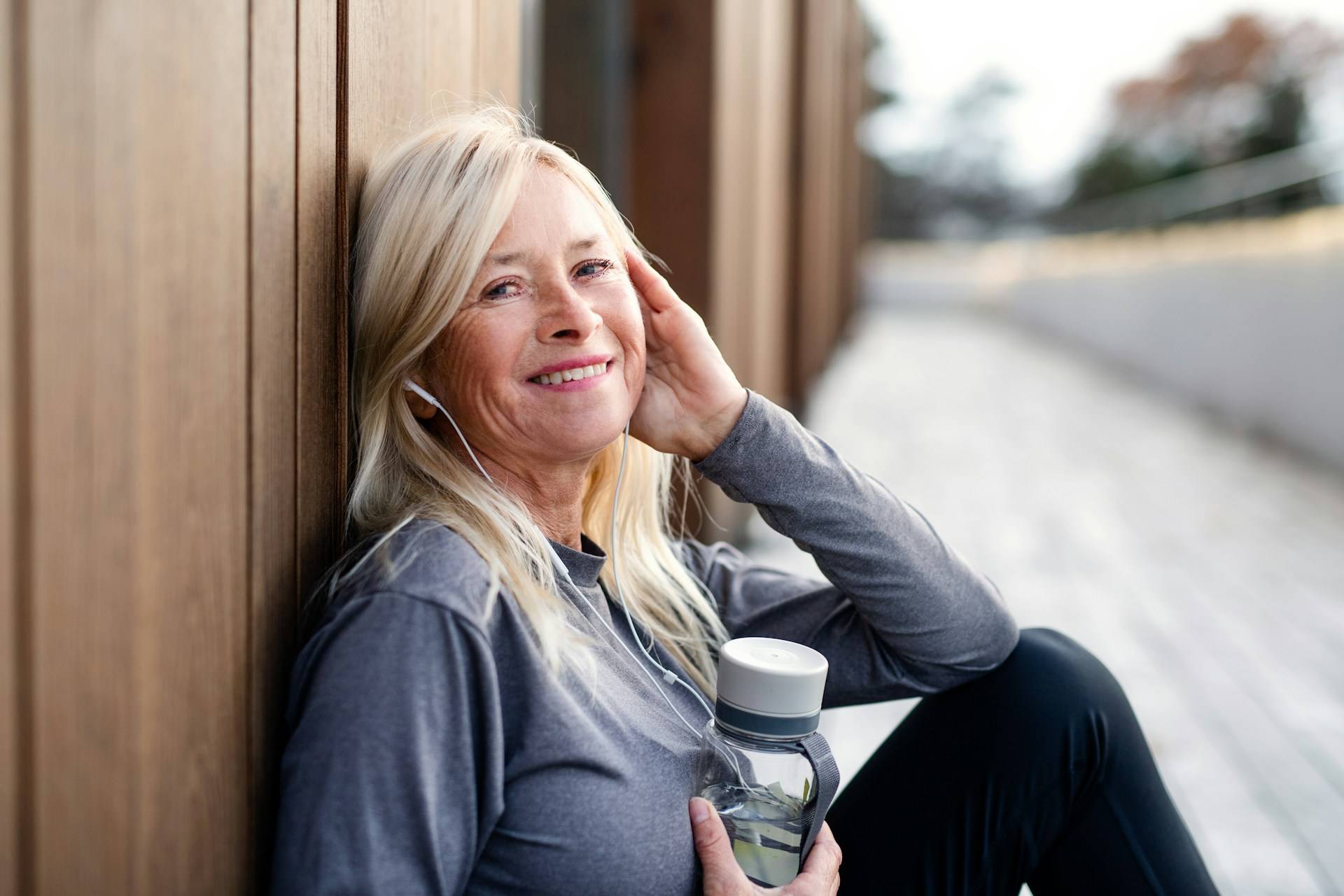 A midlife woman with coffee in hand, dreaming about her life.