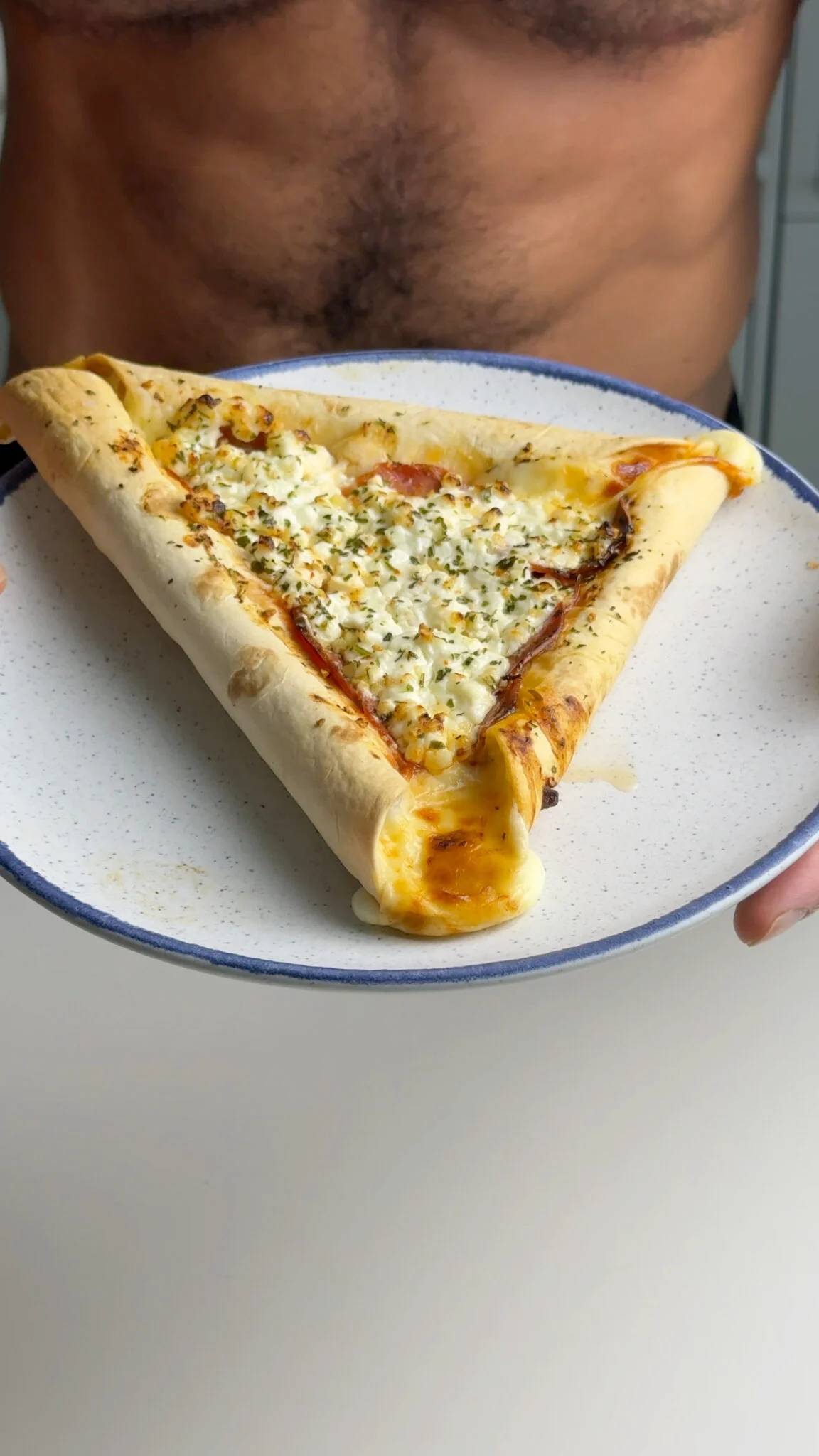 008 finished pizza — Jacob holding the air fryer stuffed-crust pizza