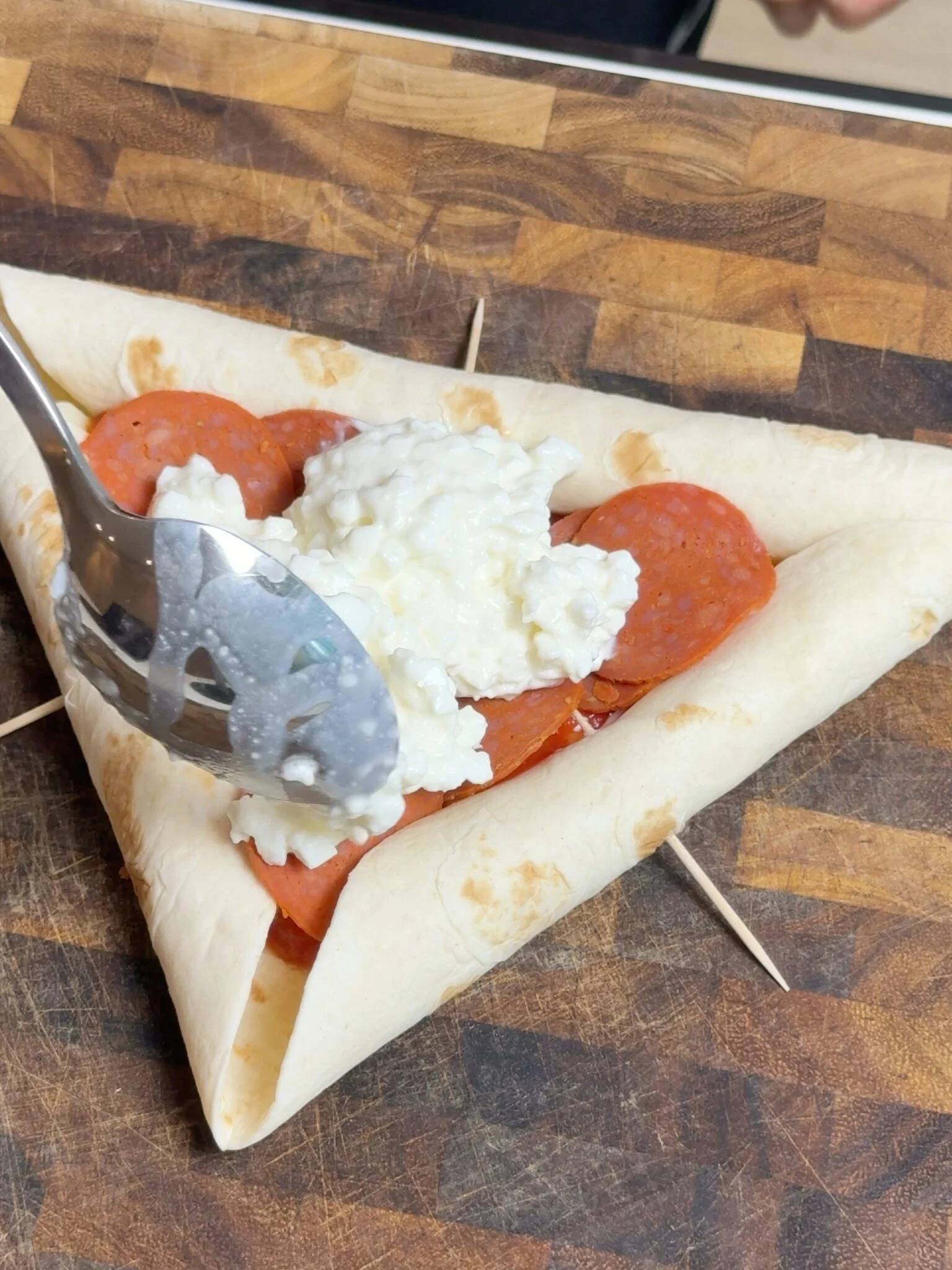 008 pizza preparation — Cottage cheese and pepperoni in the folded tortilla