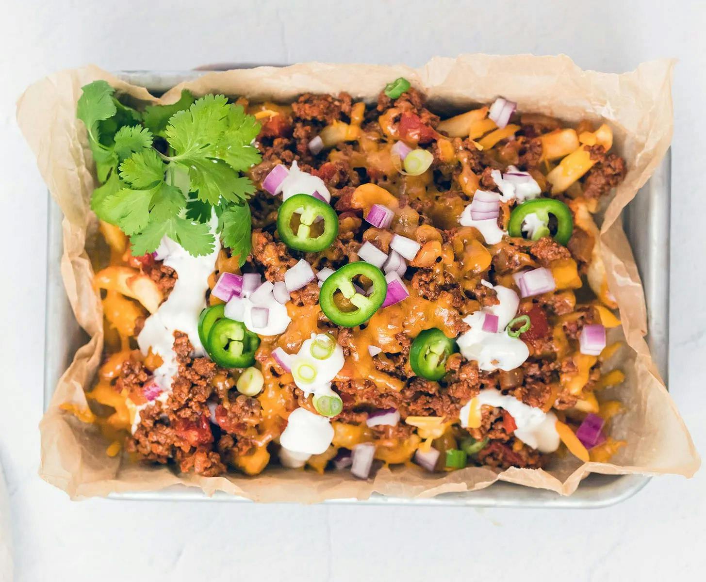 Loaded Chili Cheese Fries recipe! Crispy French fries are topped with homemade or canned chili, cheese and your favorite french fry toppings. 