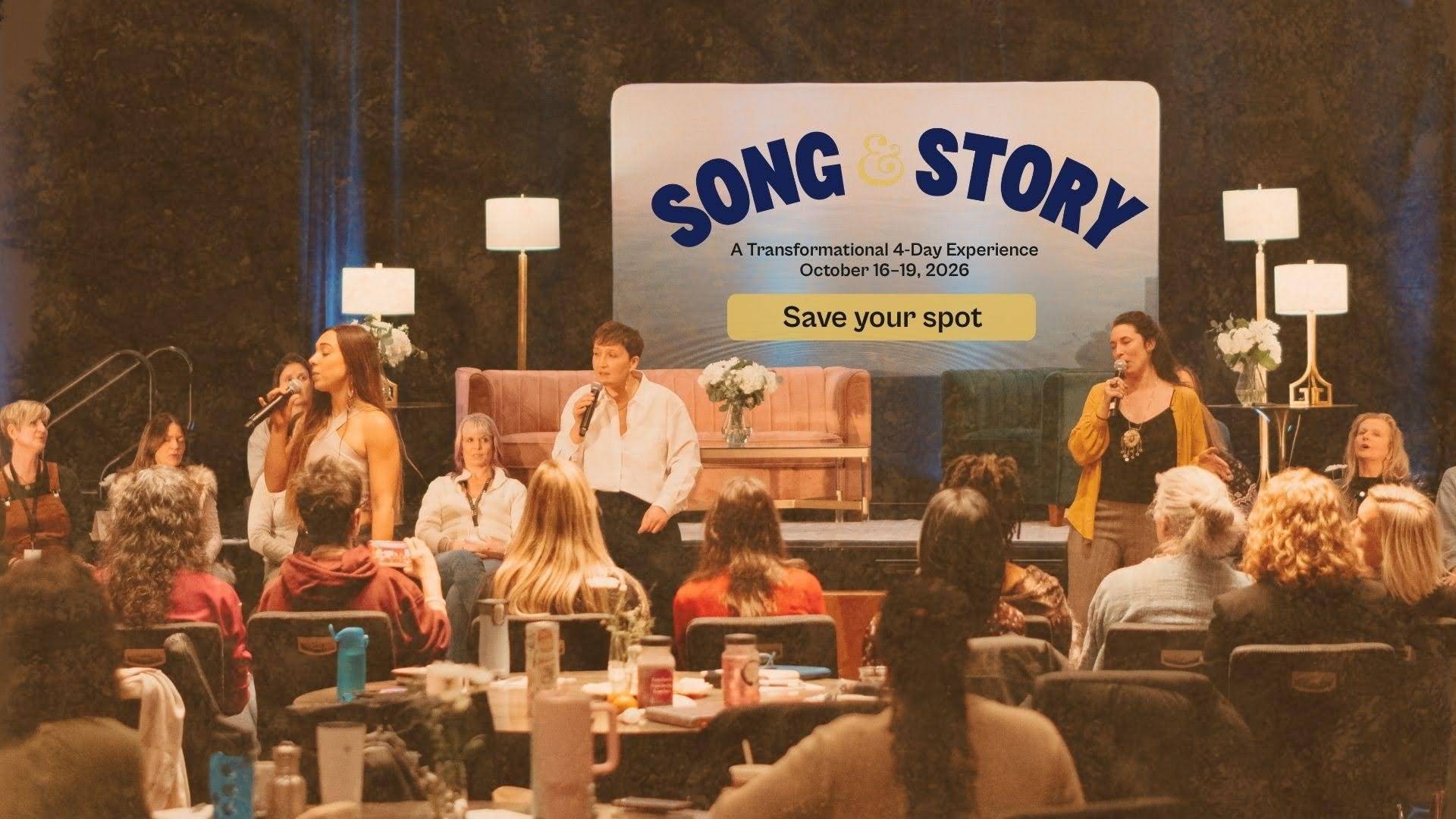 Song & Story 4-day transformational retreat with Tarzan Kay, featuring a group singing together with microphones as attendees participate in a live community experience