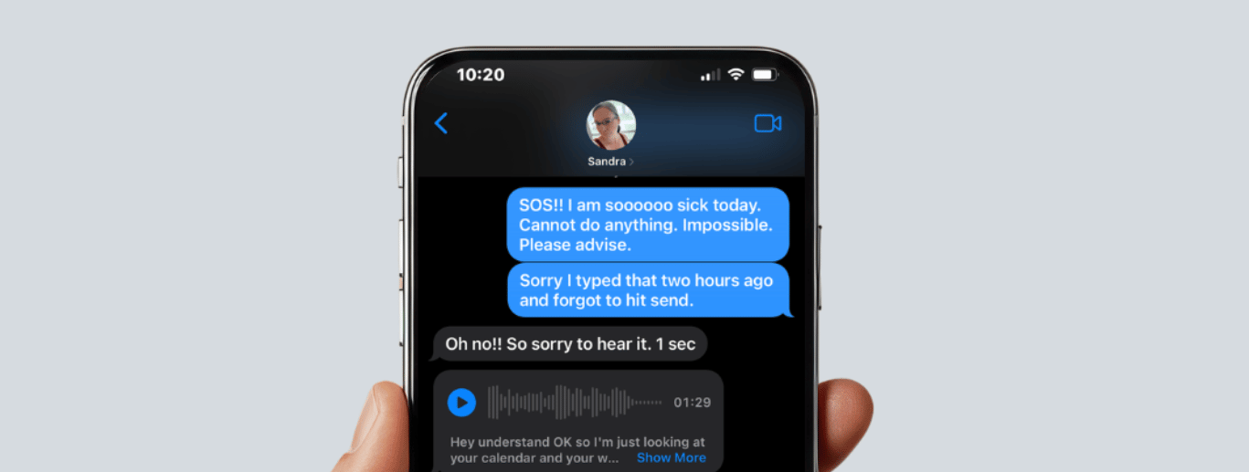 Hand holding an iPhone displaying a text message thread in dark mode, with blue message bubbles showing voice memos and a conversation about being sick and overwhelmed with email and task management.