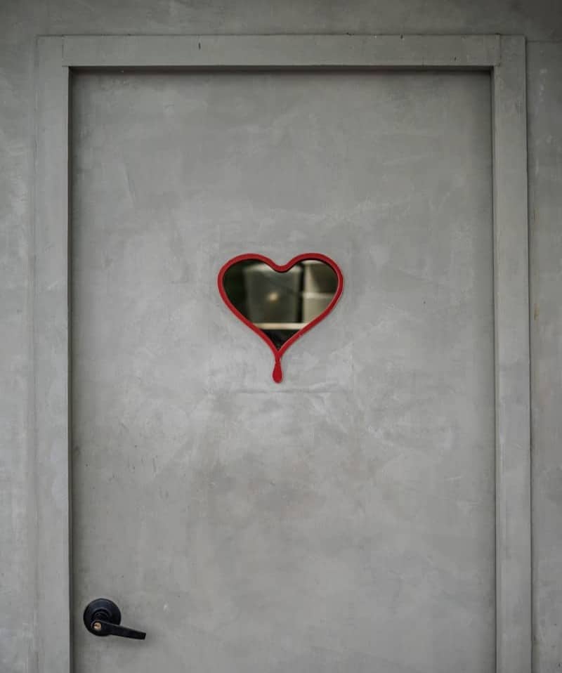 Gray door with a heart-shaped mirror
