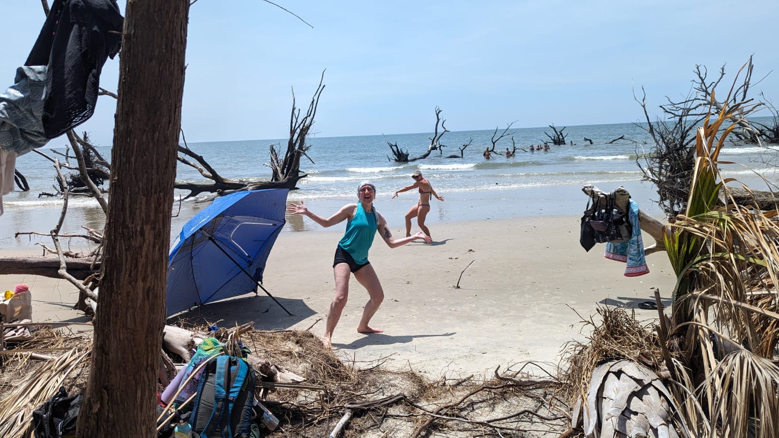 two women on a beach in silly postures