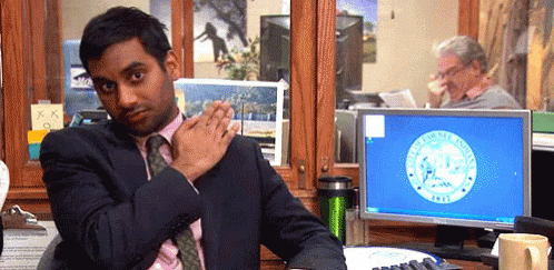 a gif of Aziz Ansari brushing his shoulder off from Parks & Recreation