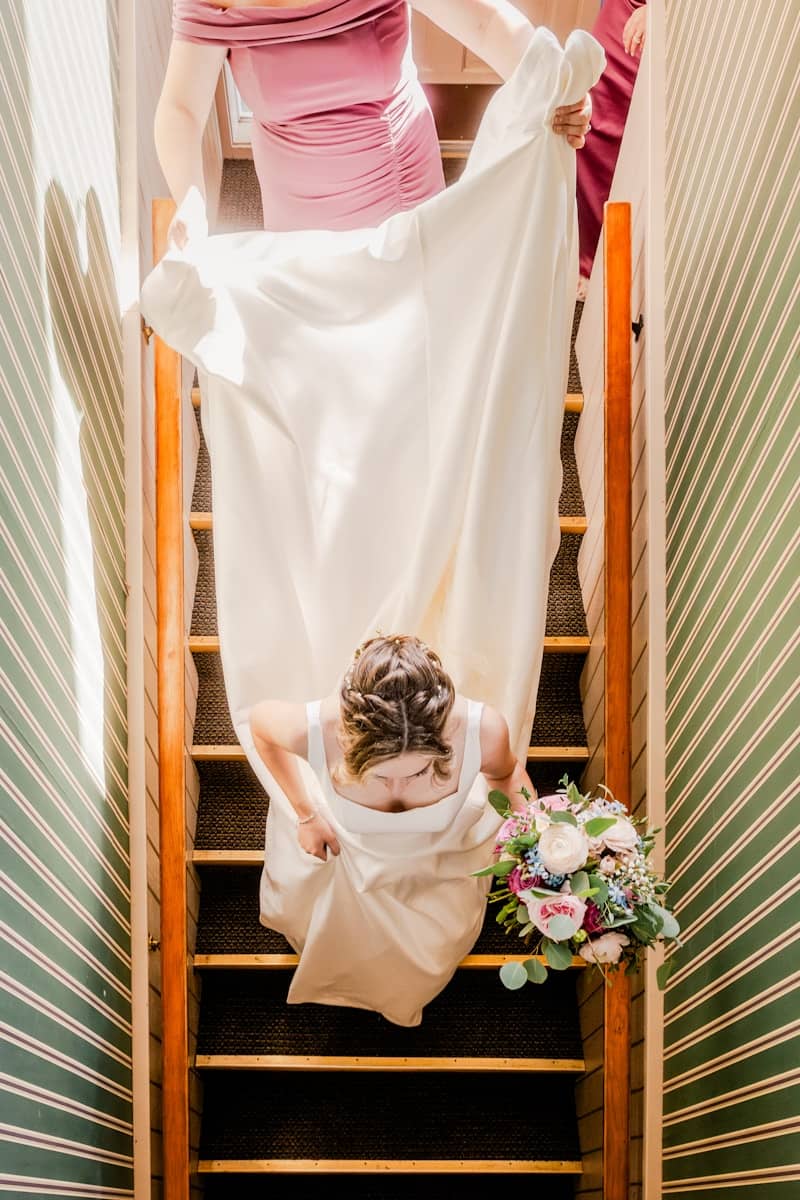 A woman in a dress is walking down a flight of stairs