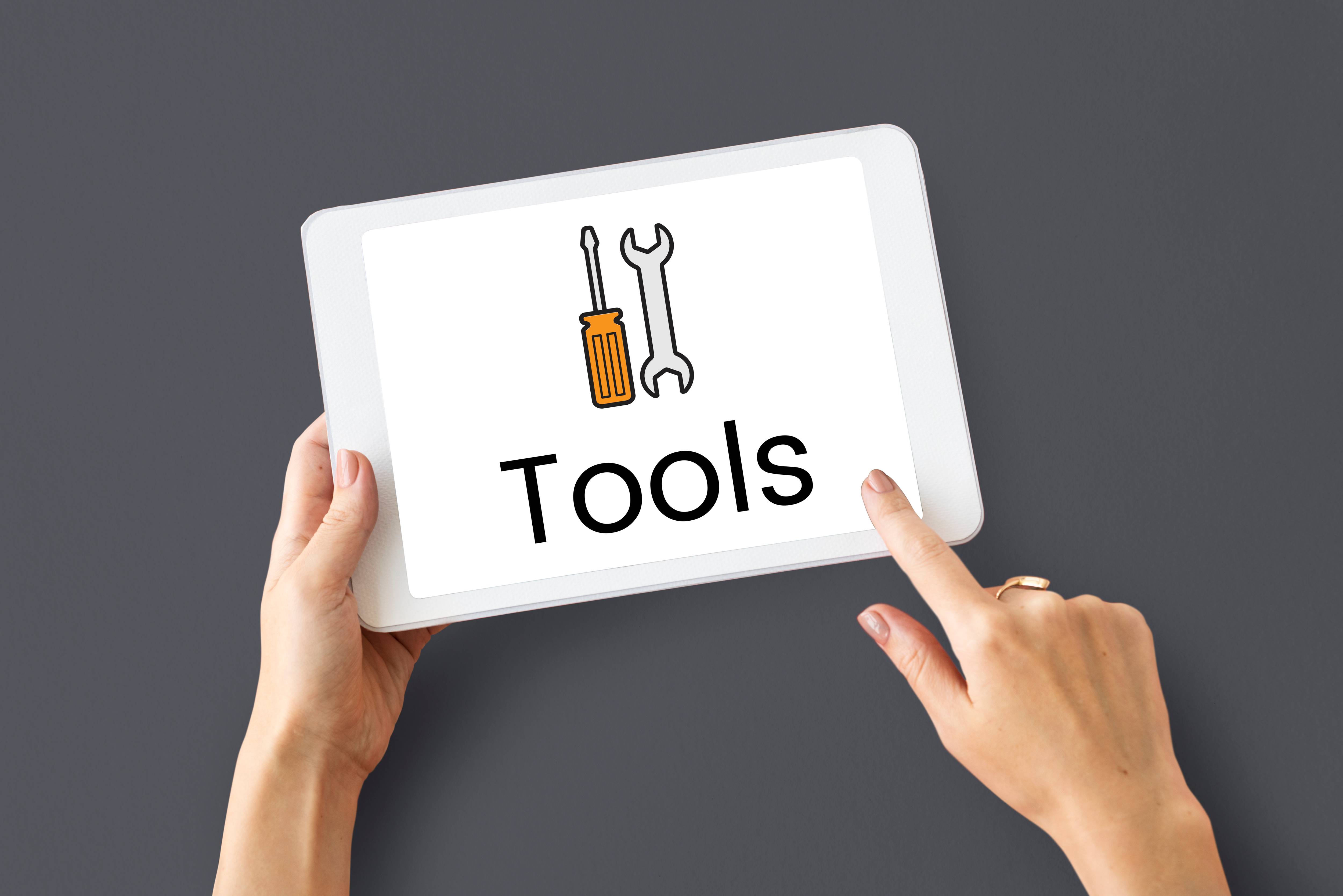 tablet showing a picture of tools and words saying tools