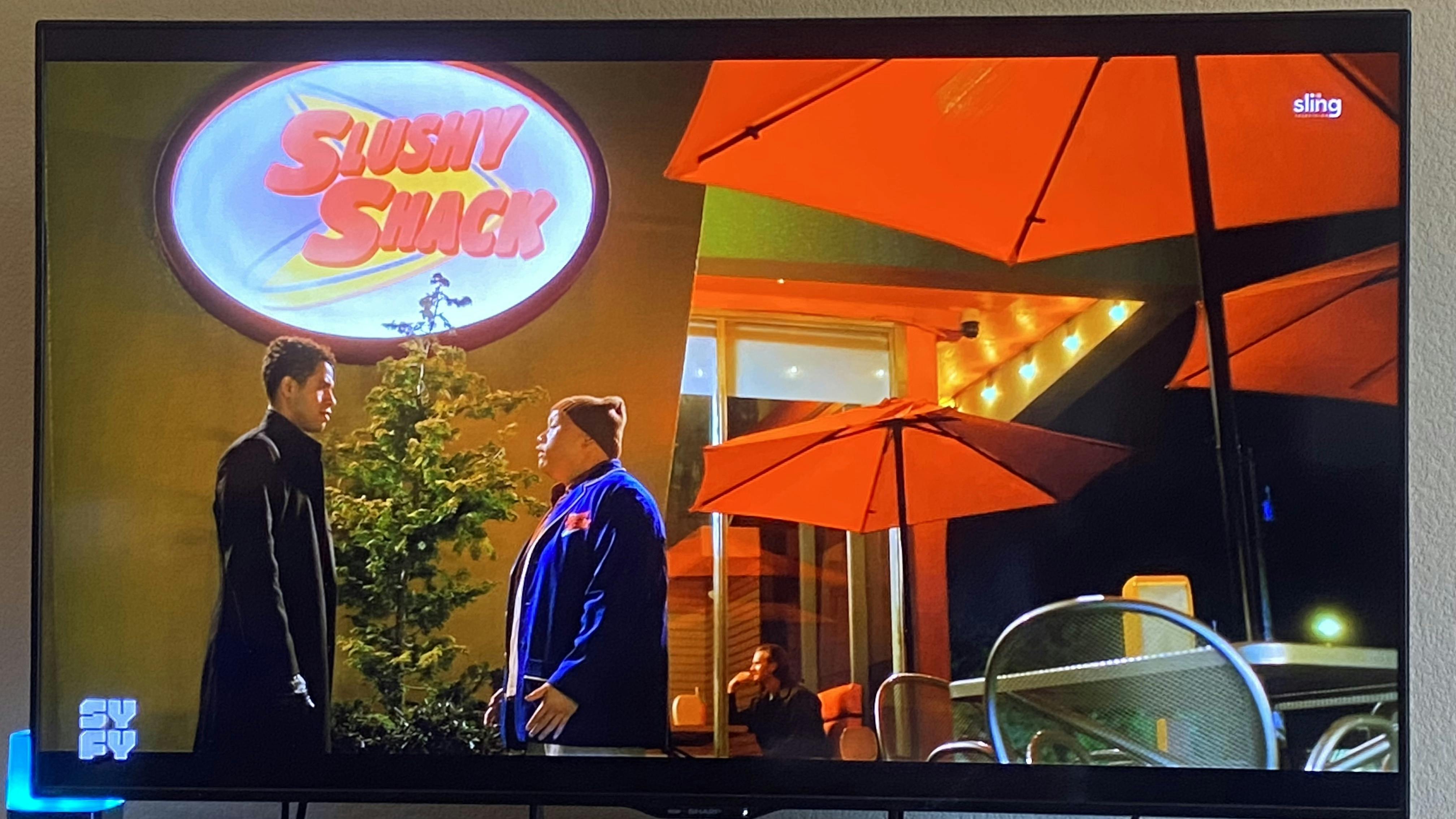 Still shot from TV show showing me in a window in the background