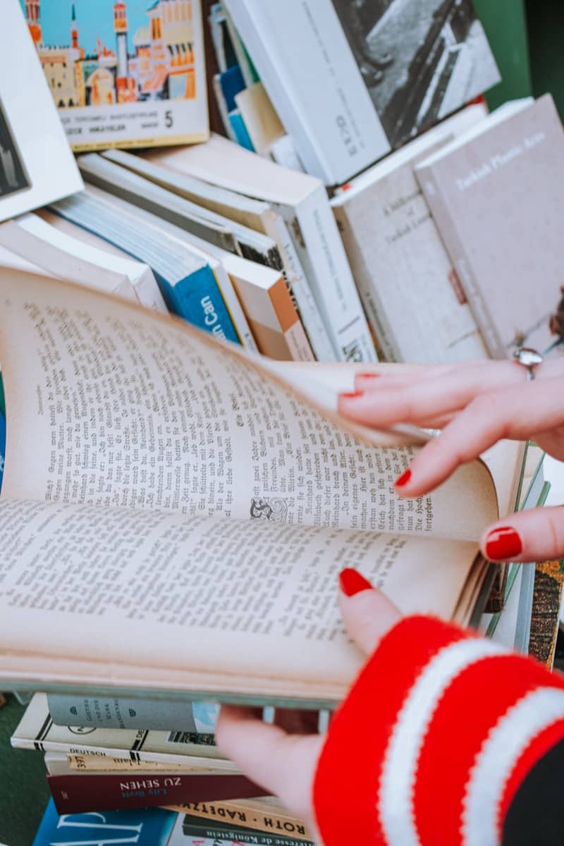 A woman is reading a book in a library