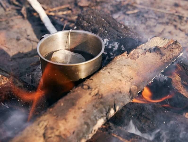 A metal bowl sitting on top of a fire