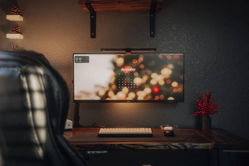 pc monitor mounted to wall with blurry image of a calendar on it