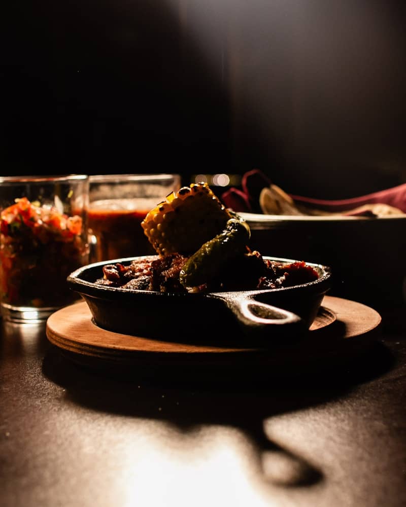 A hearty serving of chili in a cast iron skillet.