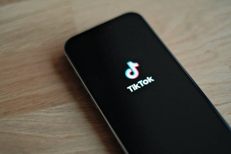 phone with TikTok logo displayed on black screen