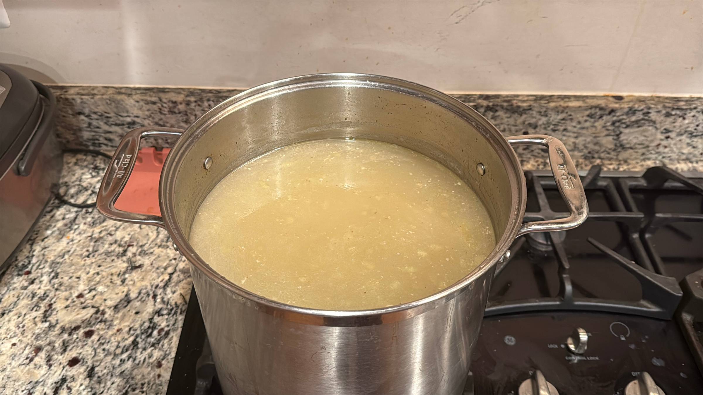 Turkey Stock cooking in a large pot on the stove.