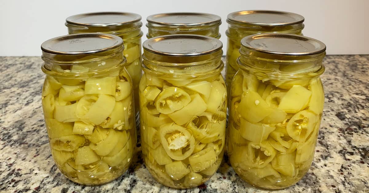 Pickled Banana Peppers in mason jars sitting on a counter