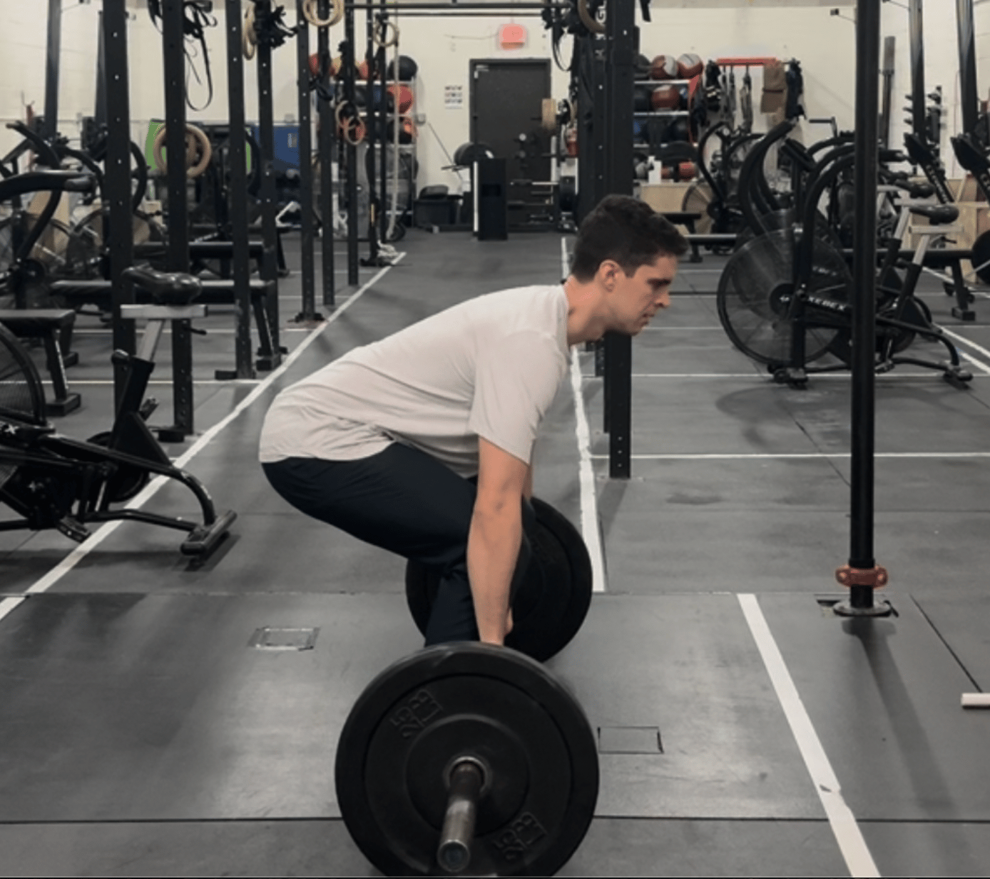 An individual doing a conventional barbell deadlift