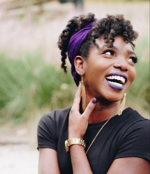 photo of woman wearing purple lipstick and black crew-neck shirt