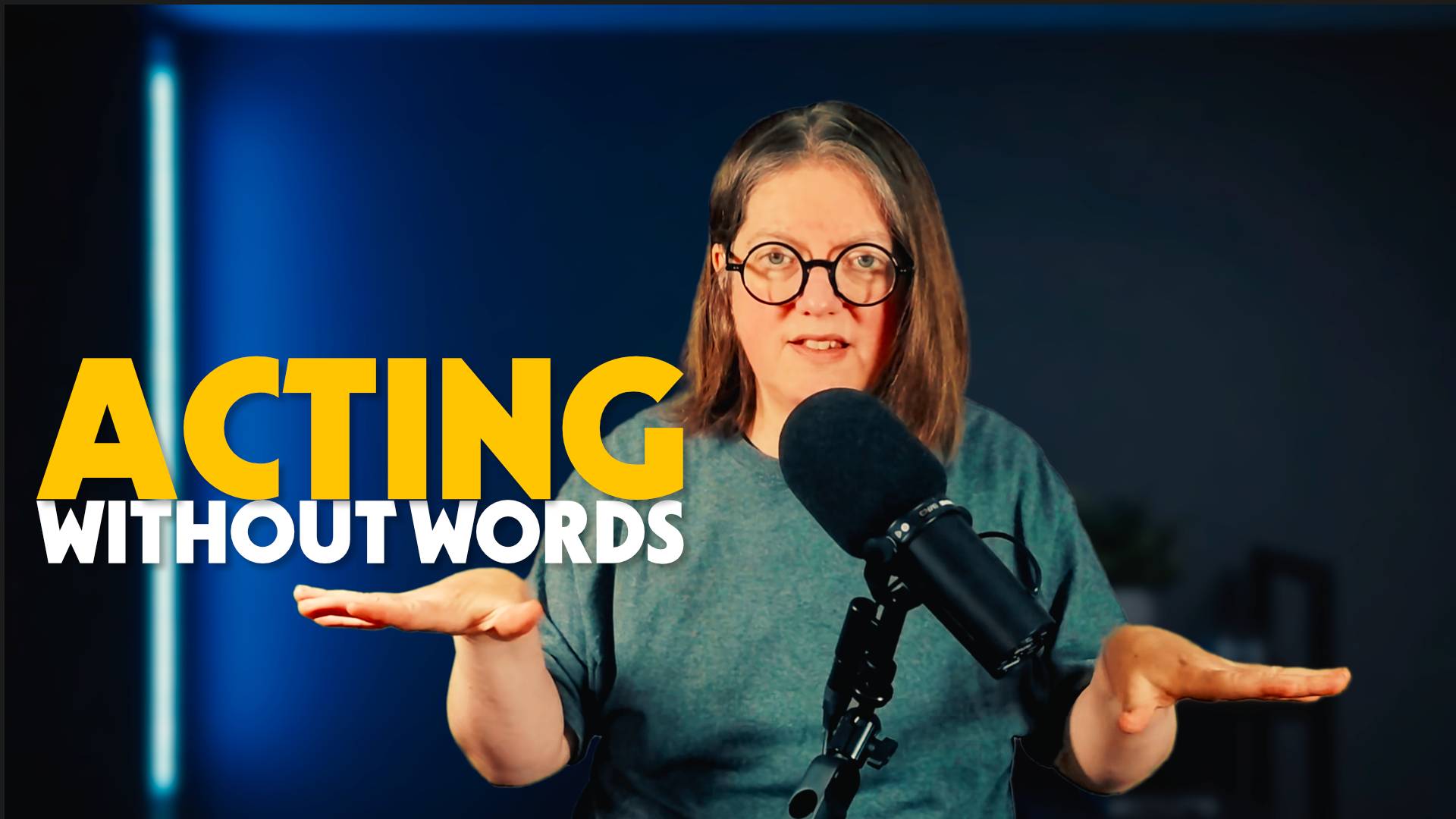 Jen standing in front of a dark background and behind a microphone with the words next to her "Acting without words"