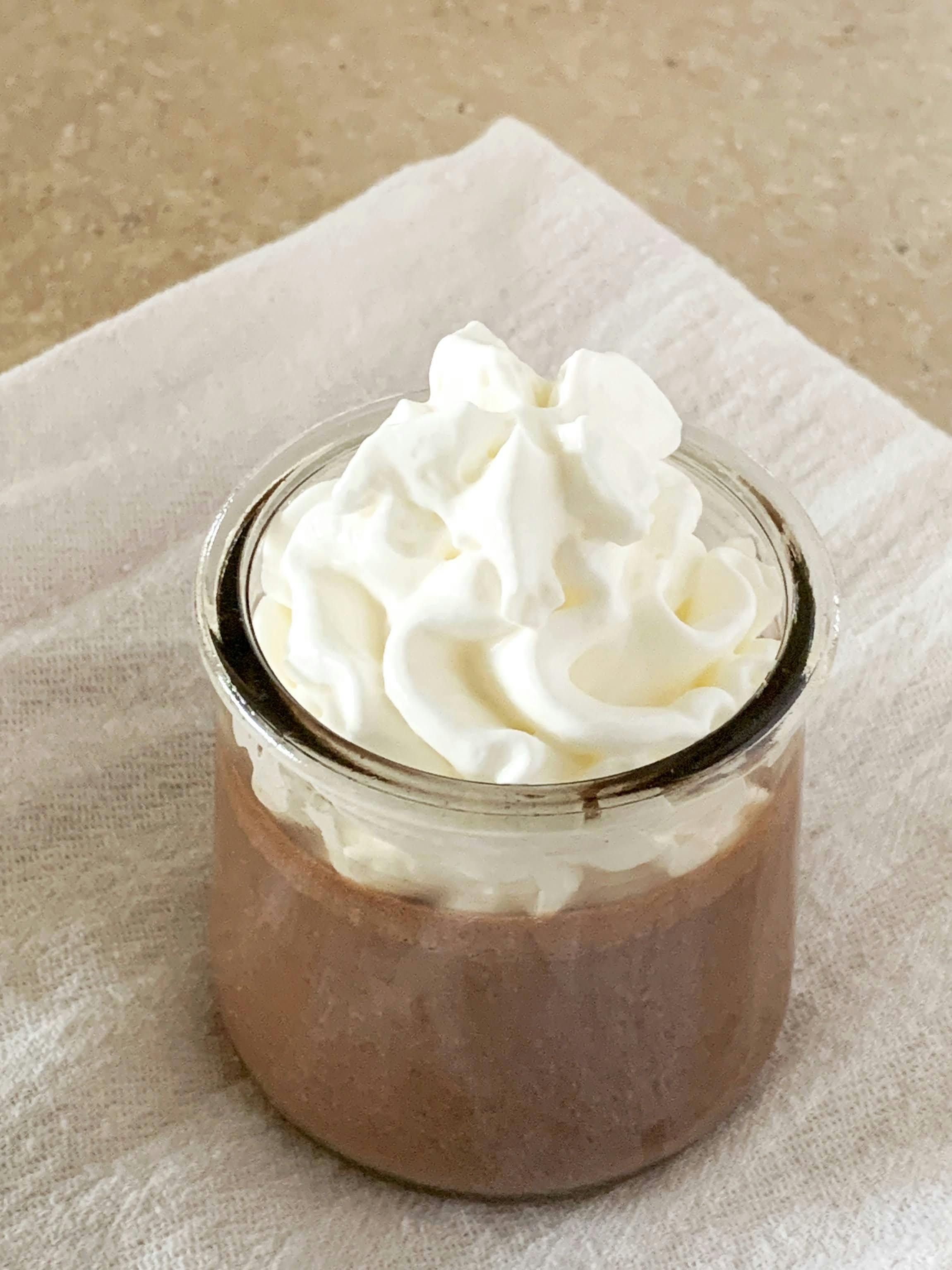 Chocolate pots de creme topped with whipped cream