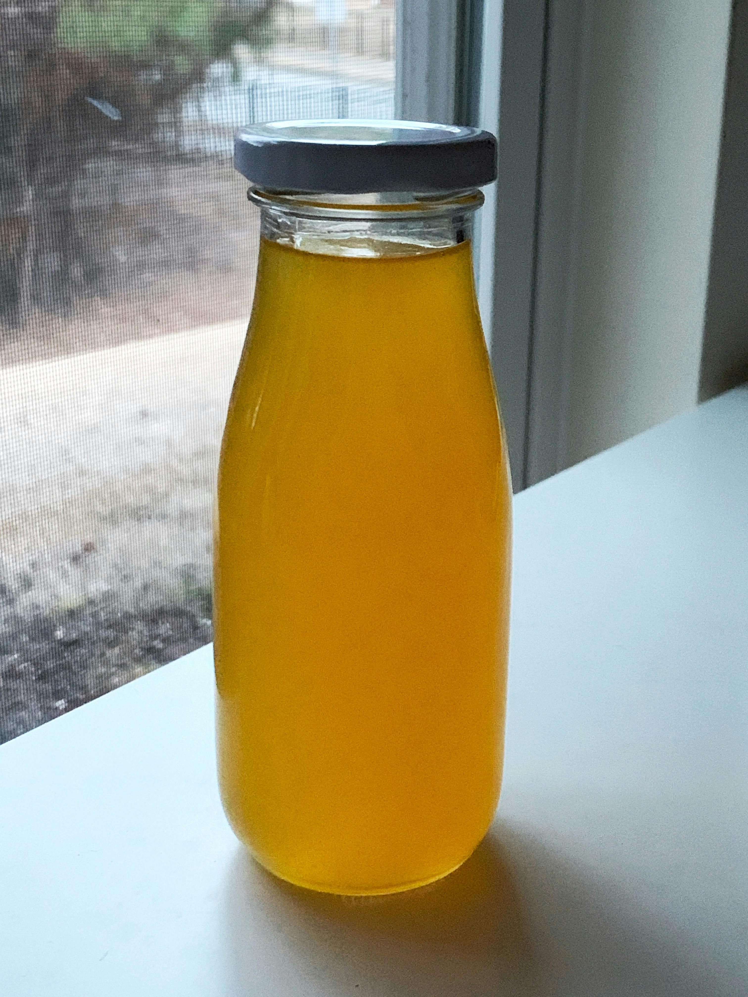 Homemade mandarin orange simple syrup recipe made in a glass bottle