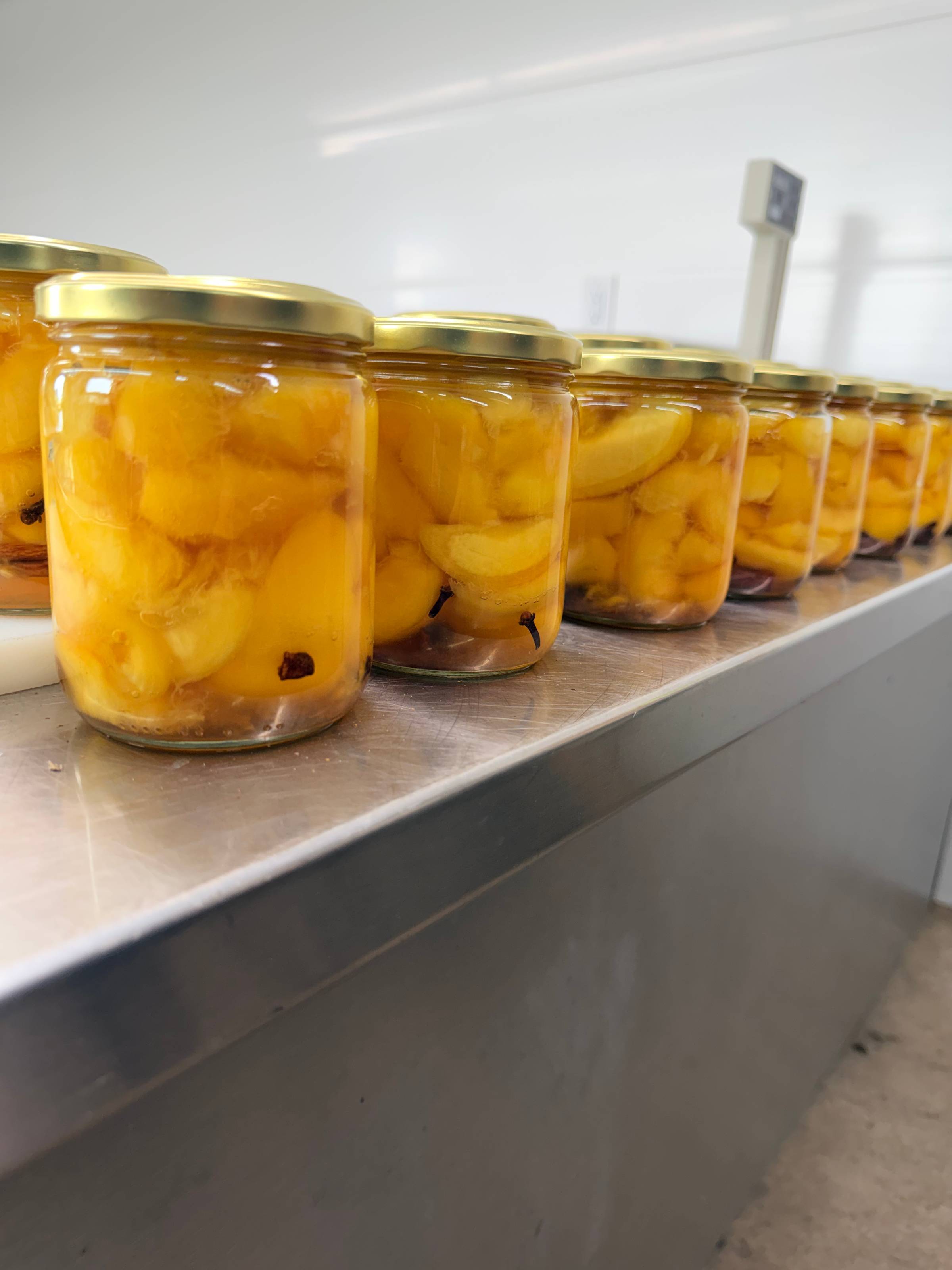 Finished jars of spiced canned peaches