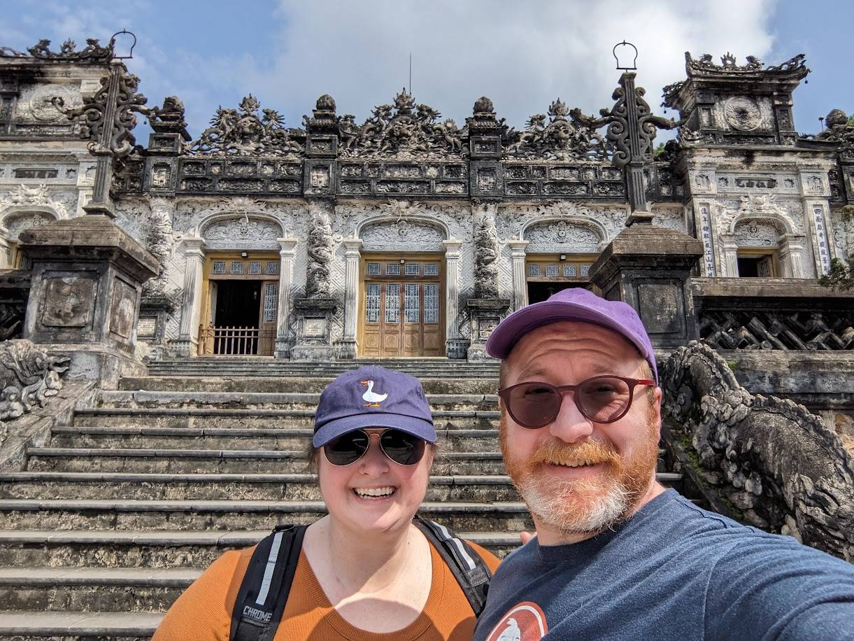 Carolyn and her husband at a royal tomb in Vietnam