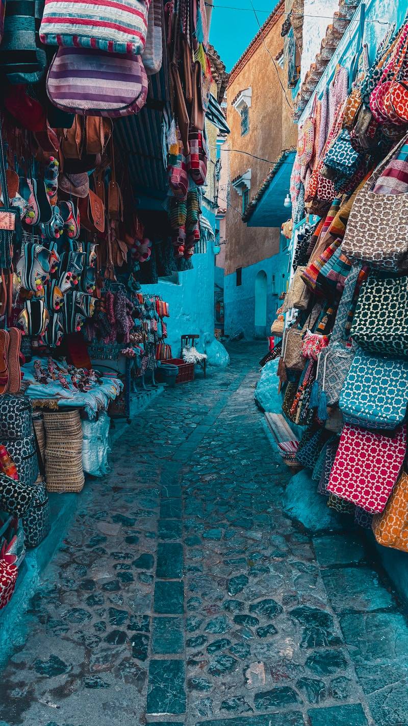 A narrow street with a lot of bags on display