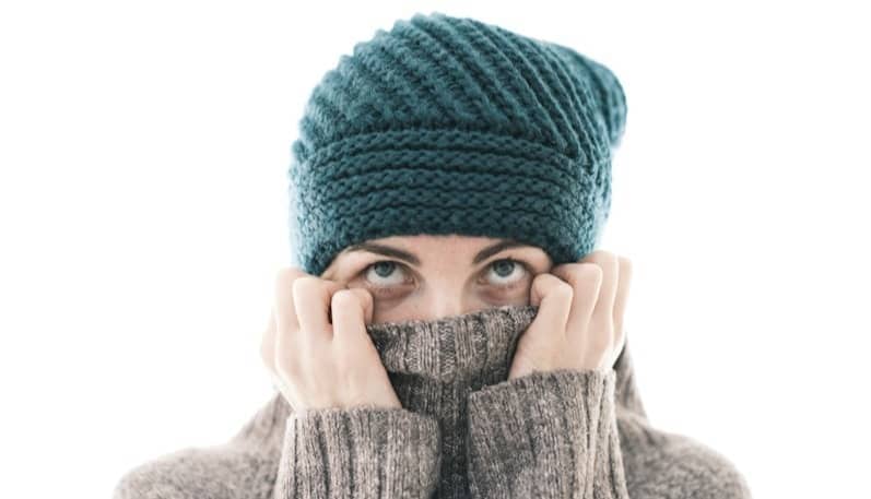 a woman covering her face with her hands