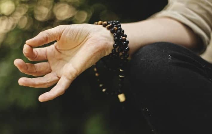 person doing meditation outdoors