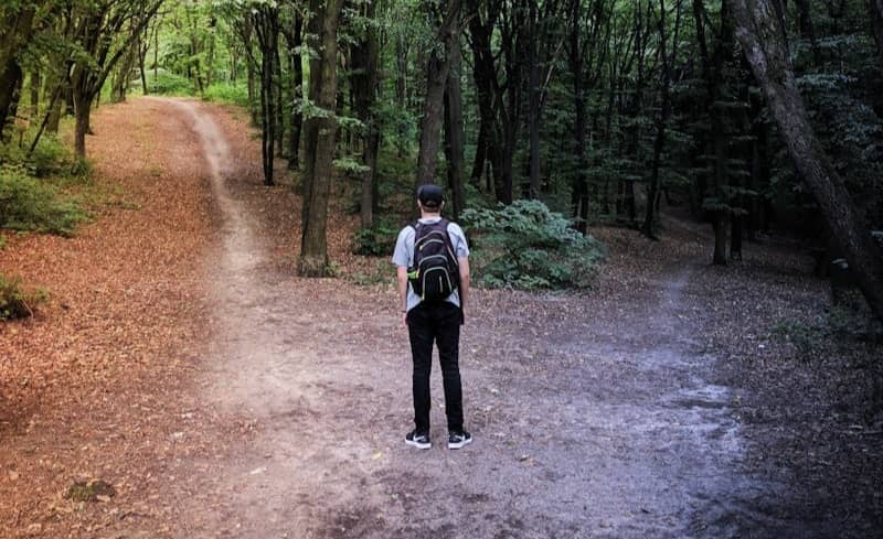 man standing in the middle of woods