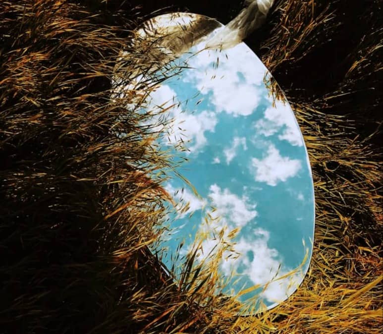 round mirror on grass