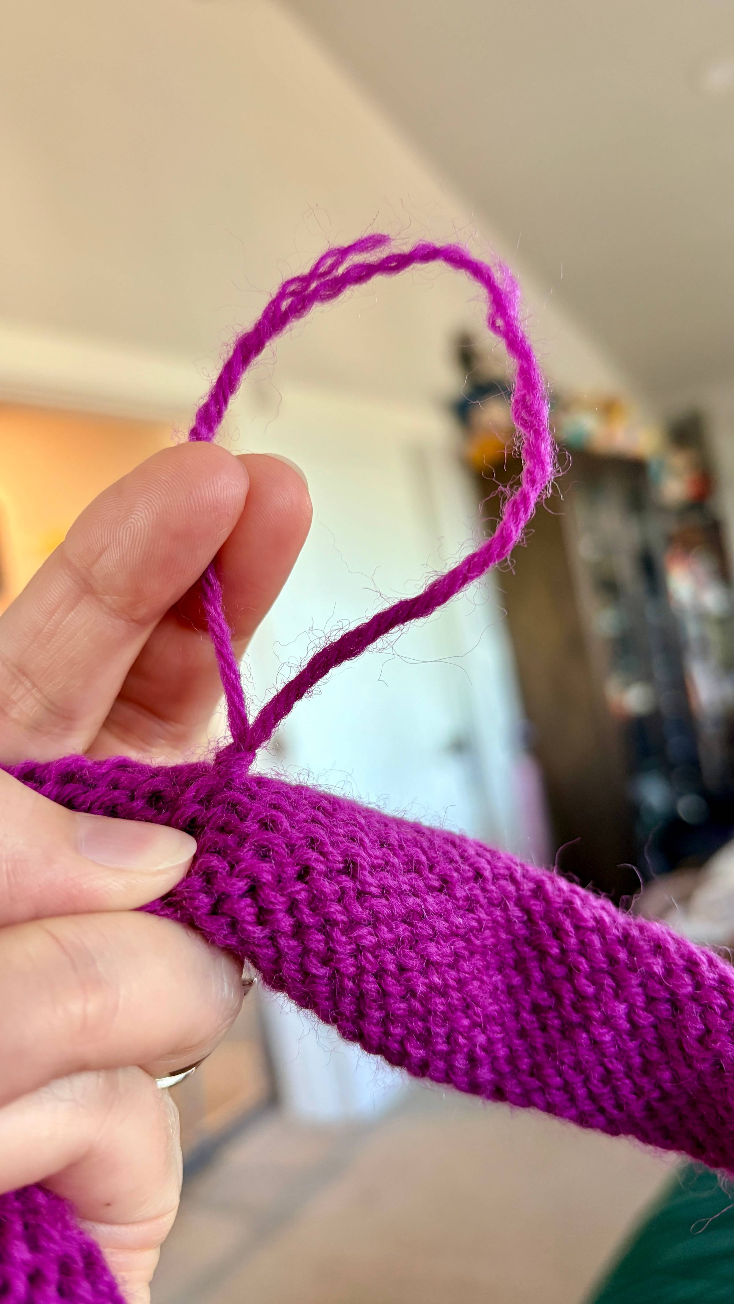 knitting project with a frayed loop of yarn 