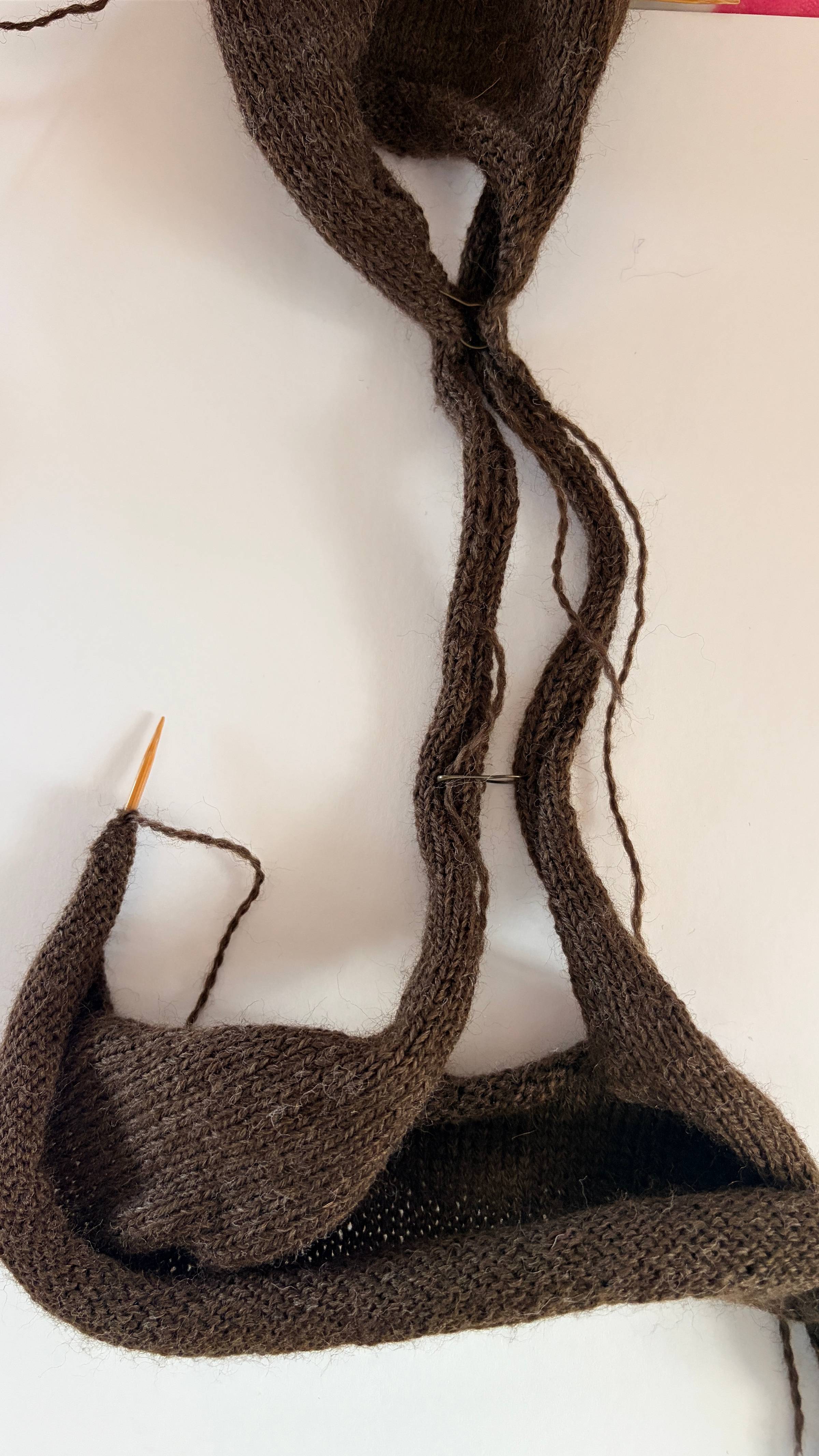tank top knitting progress with straps pinned together