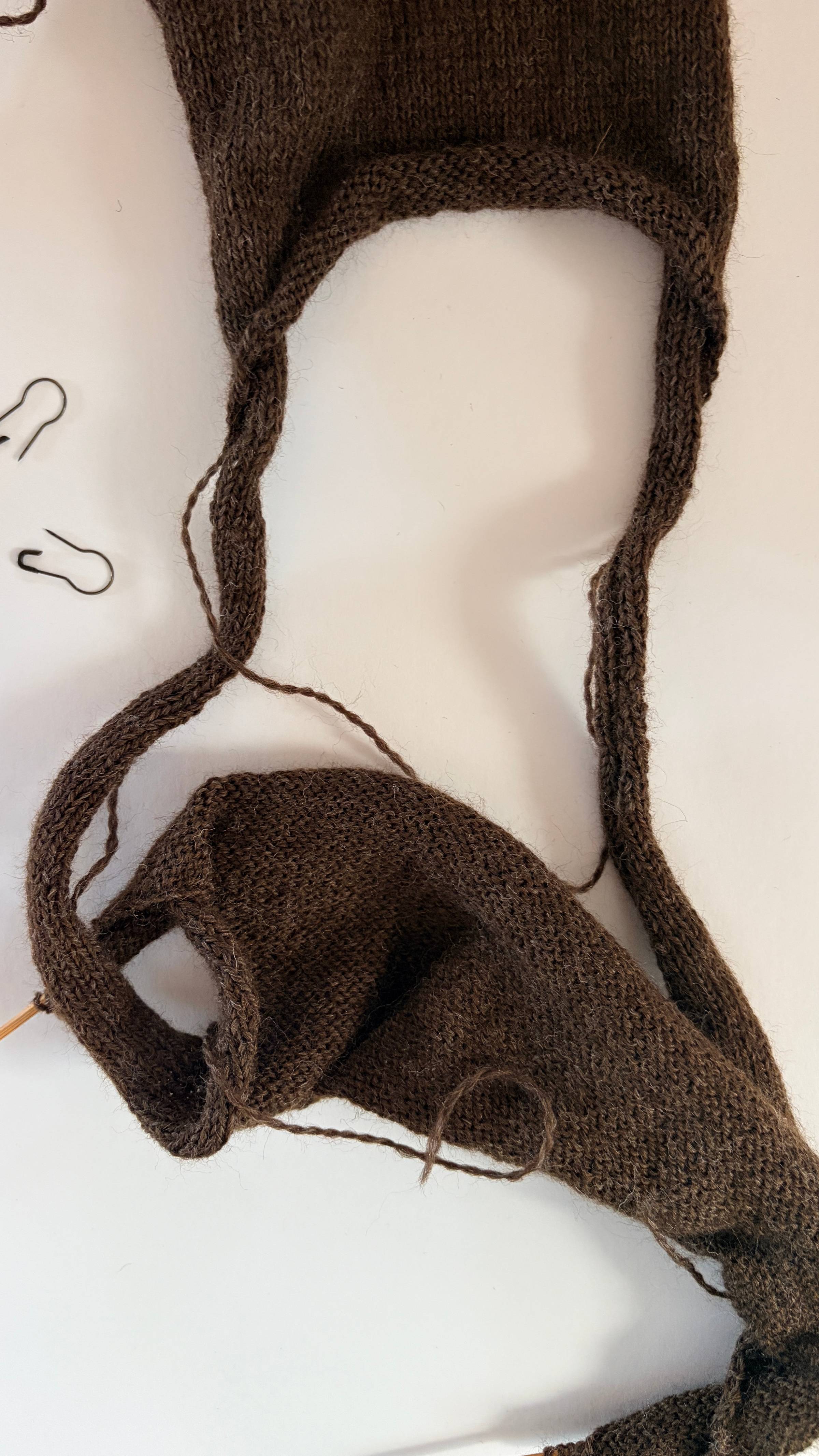 tank top knitting progress with a twist
