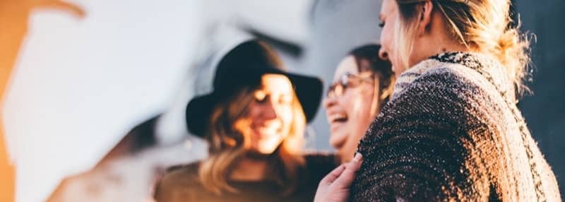 people laughing and talking outside during daytime