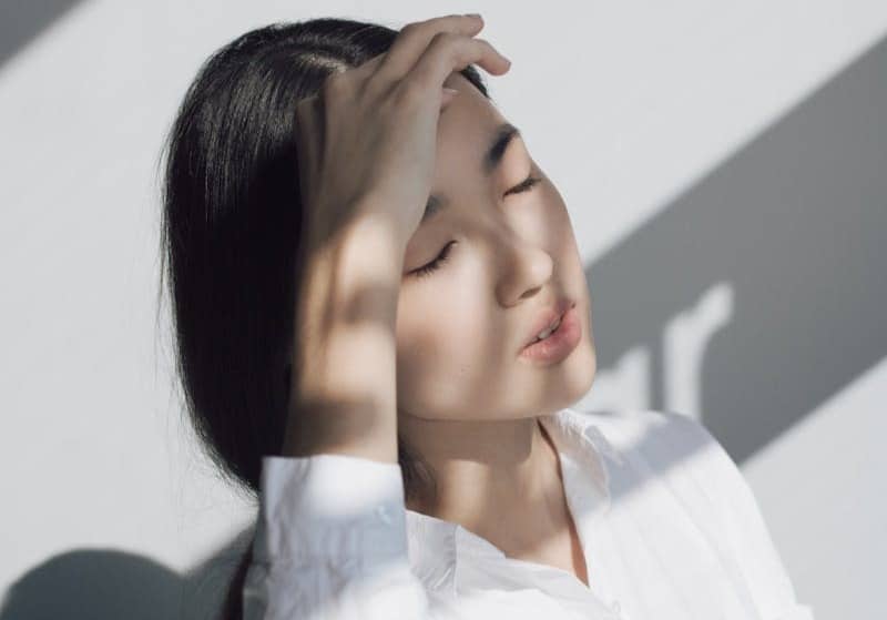 woman leaning on white table