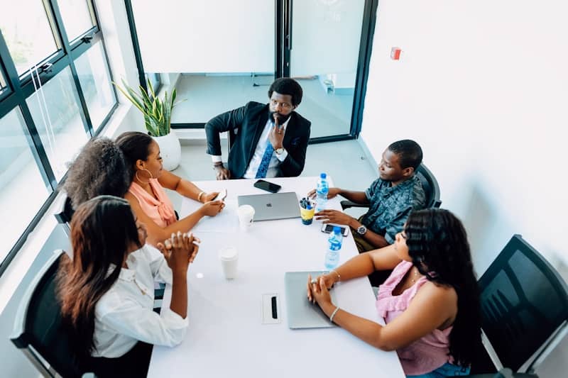 A group of people sitting around a white table