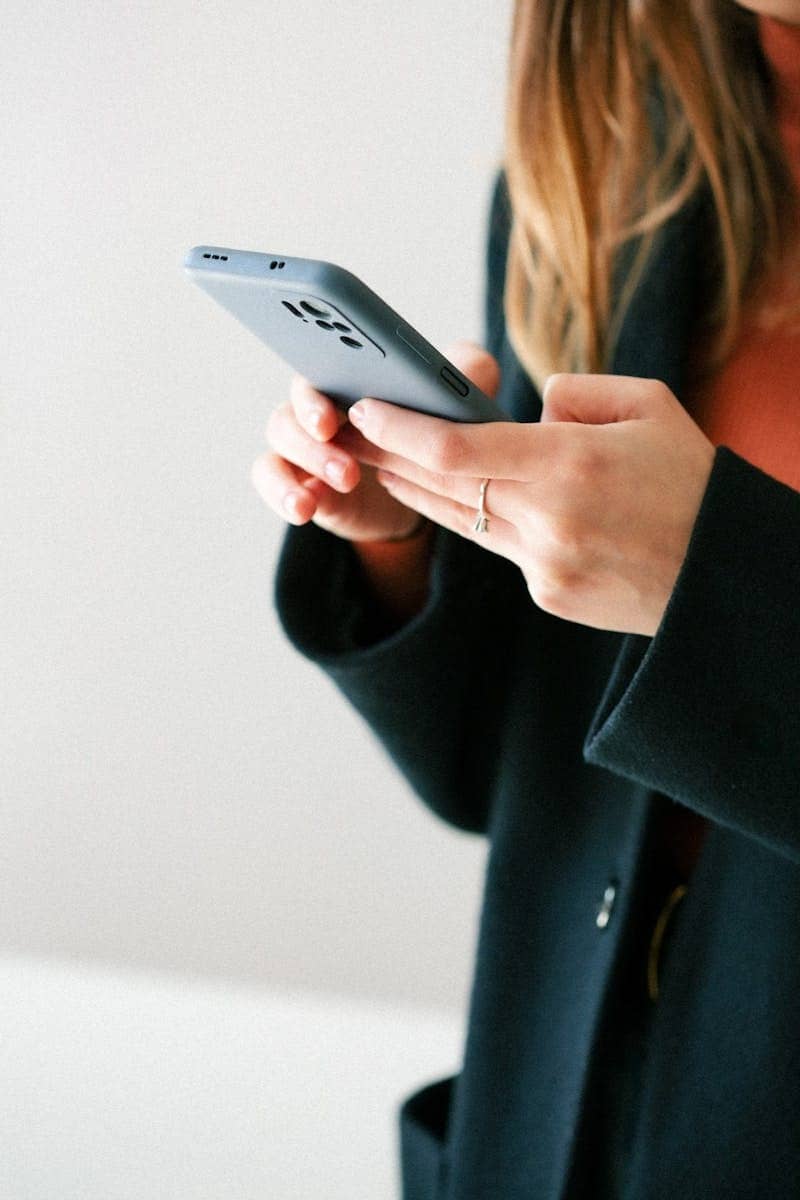 a woman holding a cell phone in her hands