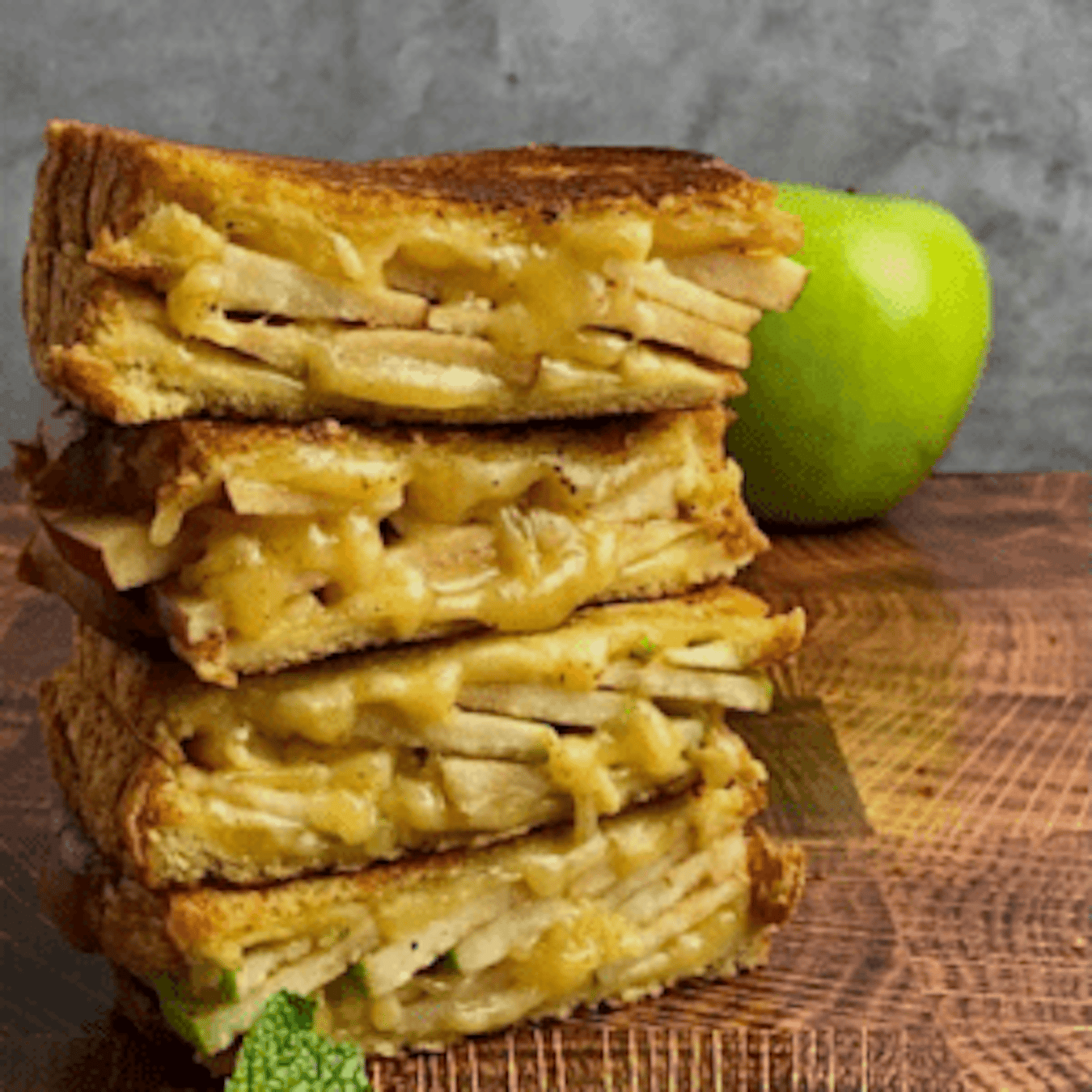 stack of apple and gouda grilled cheese showing the cross-section