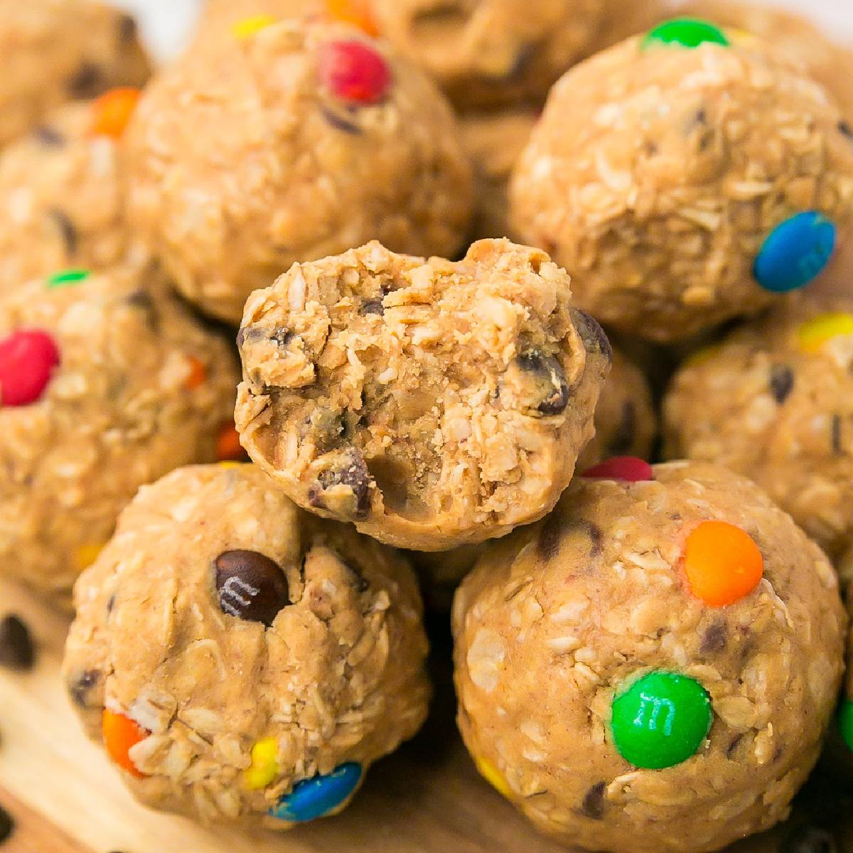 Monster cookie energy bites with one missing a bite.