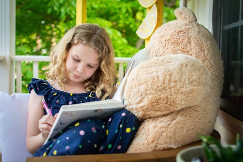 woman in red shirt reading book