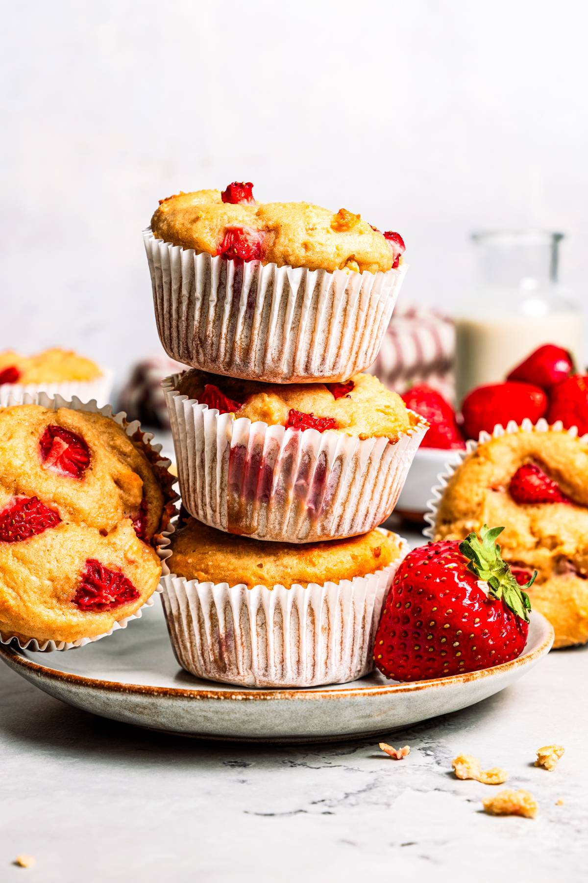 A stack of three protein muffins in liners.