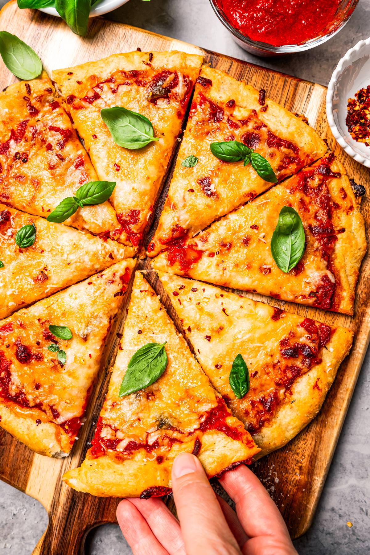 A homemade, high-protein, cottage cheese pizza cut into slices.