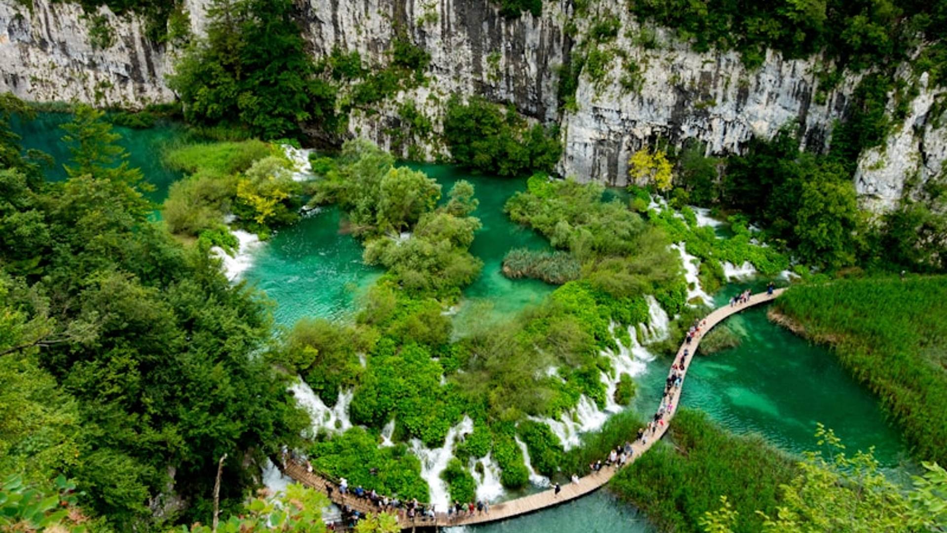 aerial view of walkway between waterfalls during daytime