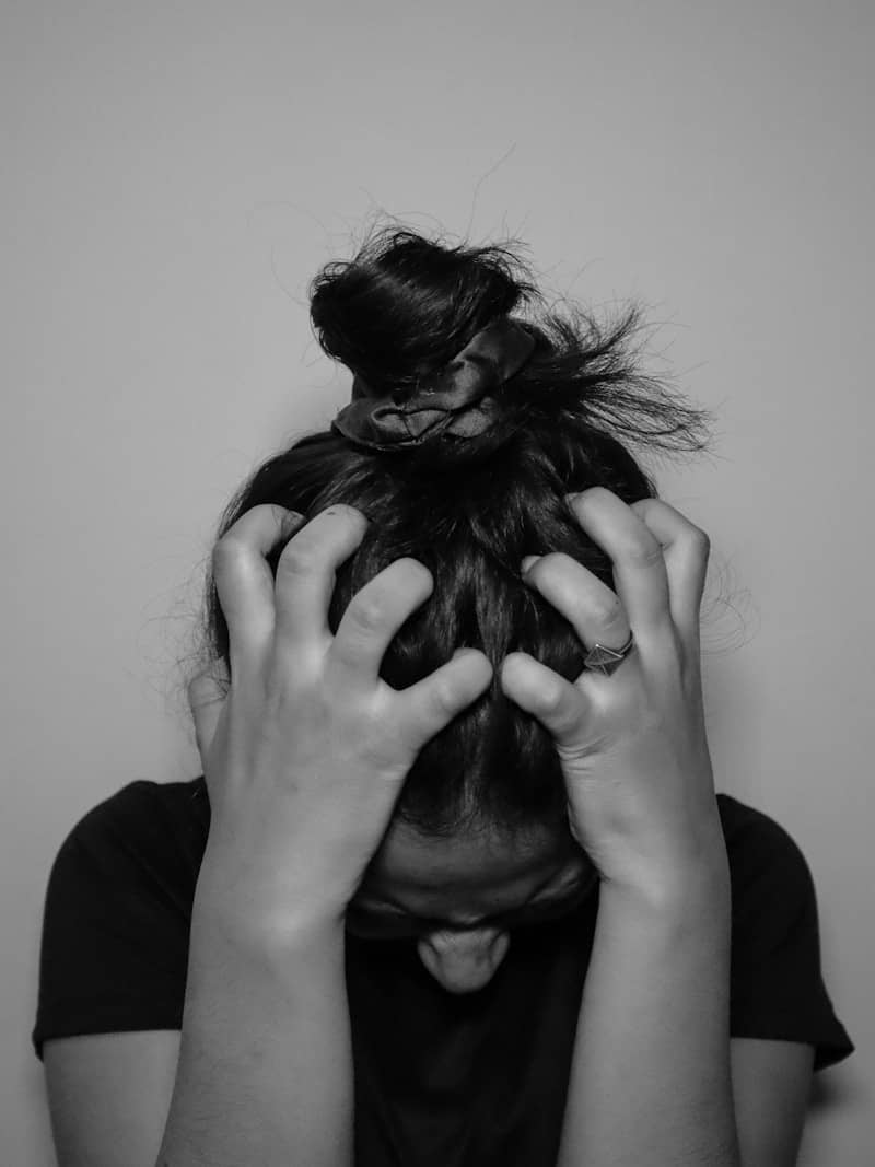 a woman covering her face with her hands