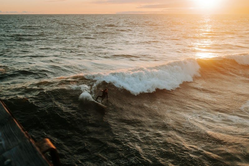a person riding a surfboard on a wave in the ocean